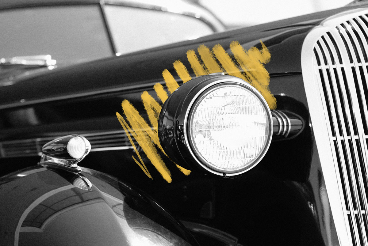 Vintage car with headlights on